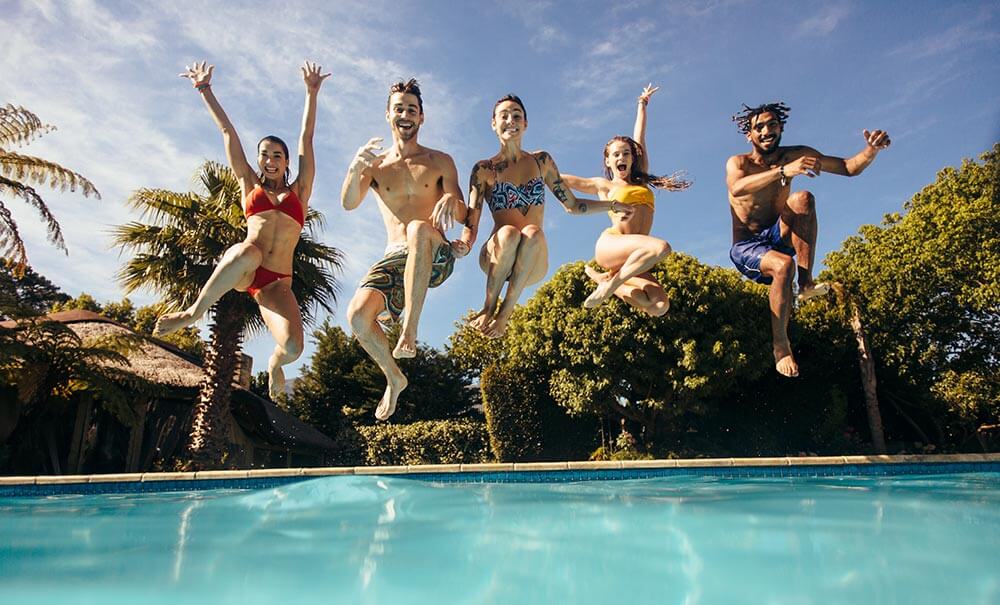 Young People Jumping Into Pool