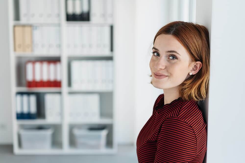 Woman leaning against a wall