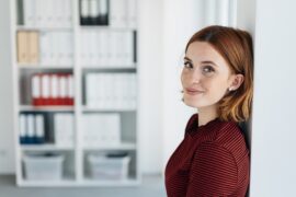 Woman Leaning Against A Wall