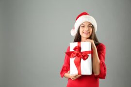 Woman in Santa hat holding gift