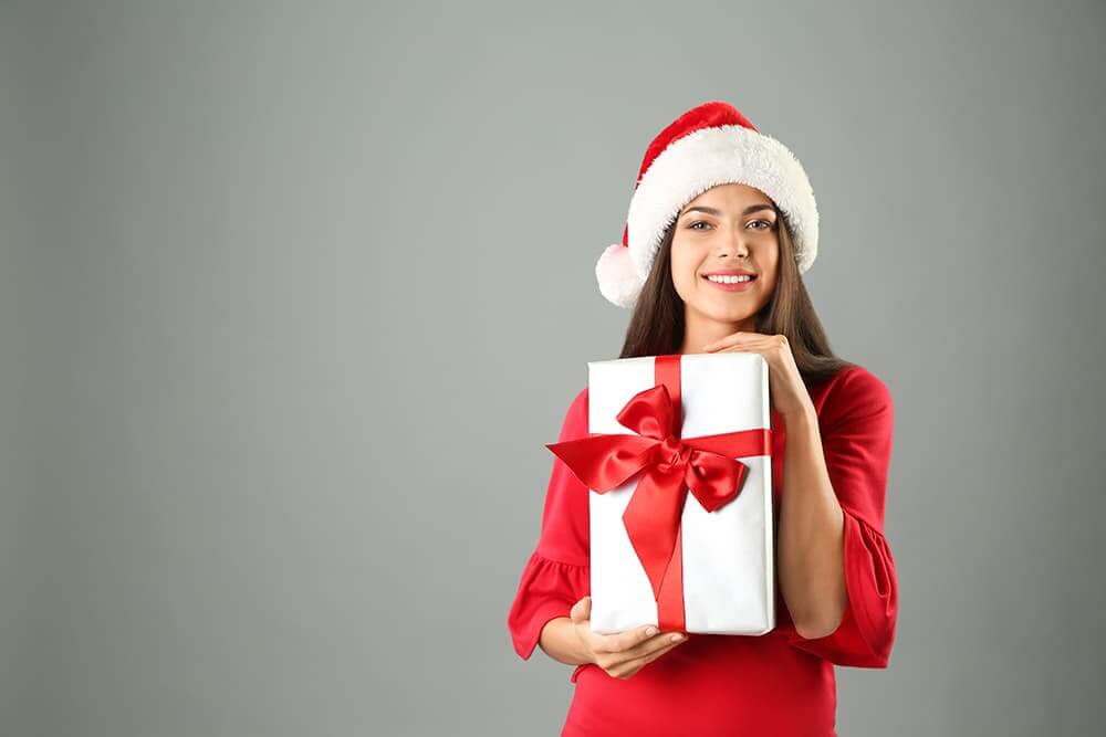 Woman in Santa Hat with Gift