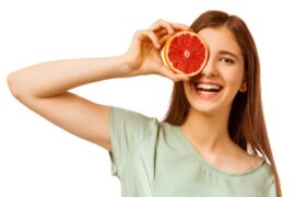 Woman holding grapefruit